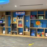 Shelves displaying artwork by kids