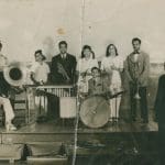 Dungill family orchestra posing with instruments on stage