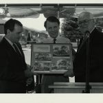 Richard M. Daley, Mike Madigan, and John B. Duff hold Clearing Branch photos.