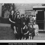 Black and white photo of several women posing outside of the library.