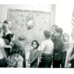 A black and white photo of a children's program in the library.