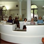 Sulzer Library Audiovisual Department staff standing behind a desk