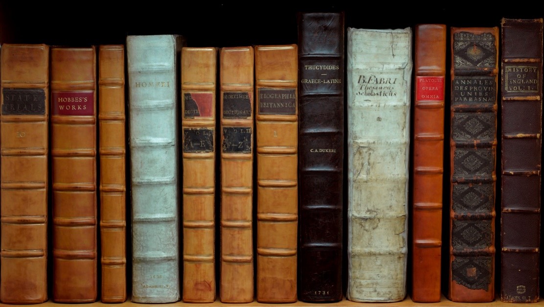 An image of a number of John Adams' books arranged on a shelf.