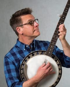 Photograph of performer, Jim Gill, playing a banjo