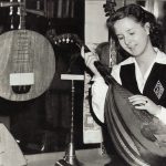 Phyllis Sands examines one of the old musical instruments in the Central Library, November 11, 1946. From the monogrammed jumper and the white shirt with French cuffs that Phyllis is wearing, we know she was a pupil at St. Joseph's Academy.