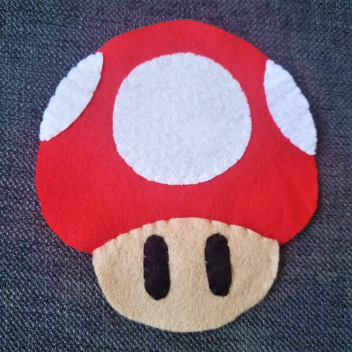 Image of front face piece sewn to front red mushroom top