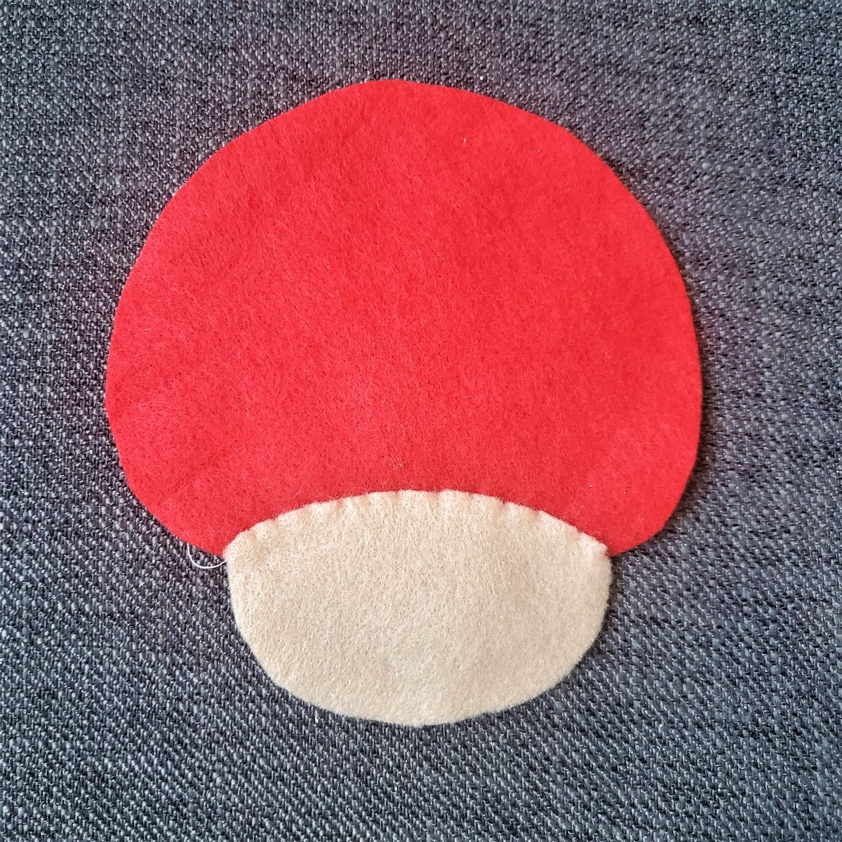 Image of the blank tan face piece and blank red mushroom back sewn together