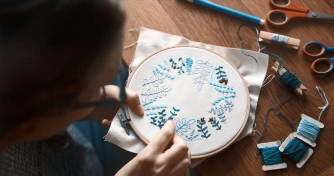 Cropped shot of an unrecognizable woman doing embroidery at home