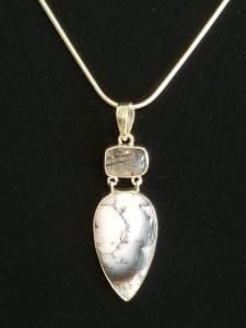 Image is of a silver necklace with a large white dendritic agate pendant