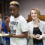 Teens hold decorated cupcakes
