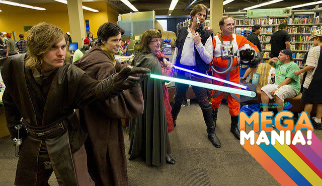 Local Star Wars fans pose with their light sabers in the PCC Library