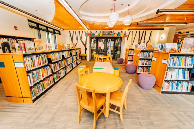 <p>Gilroy Library Downstairs Children's Area, tables, books</p>