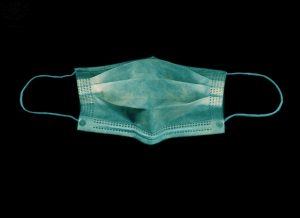 blue surgical mask with black background