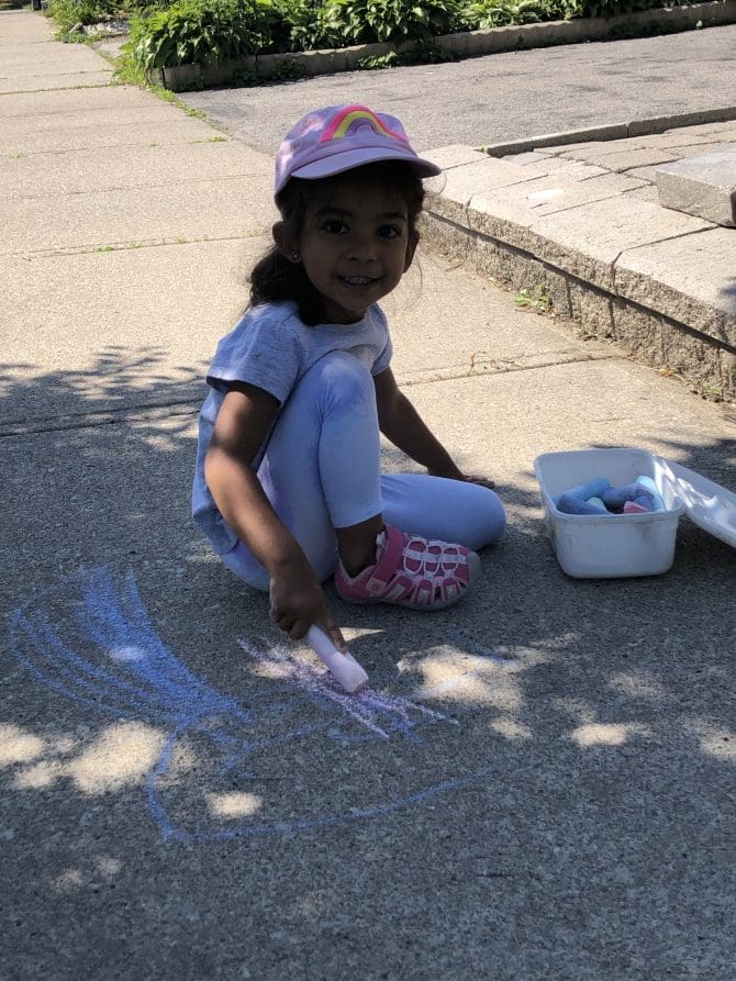 girl playing with side walk chalk