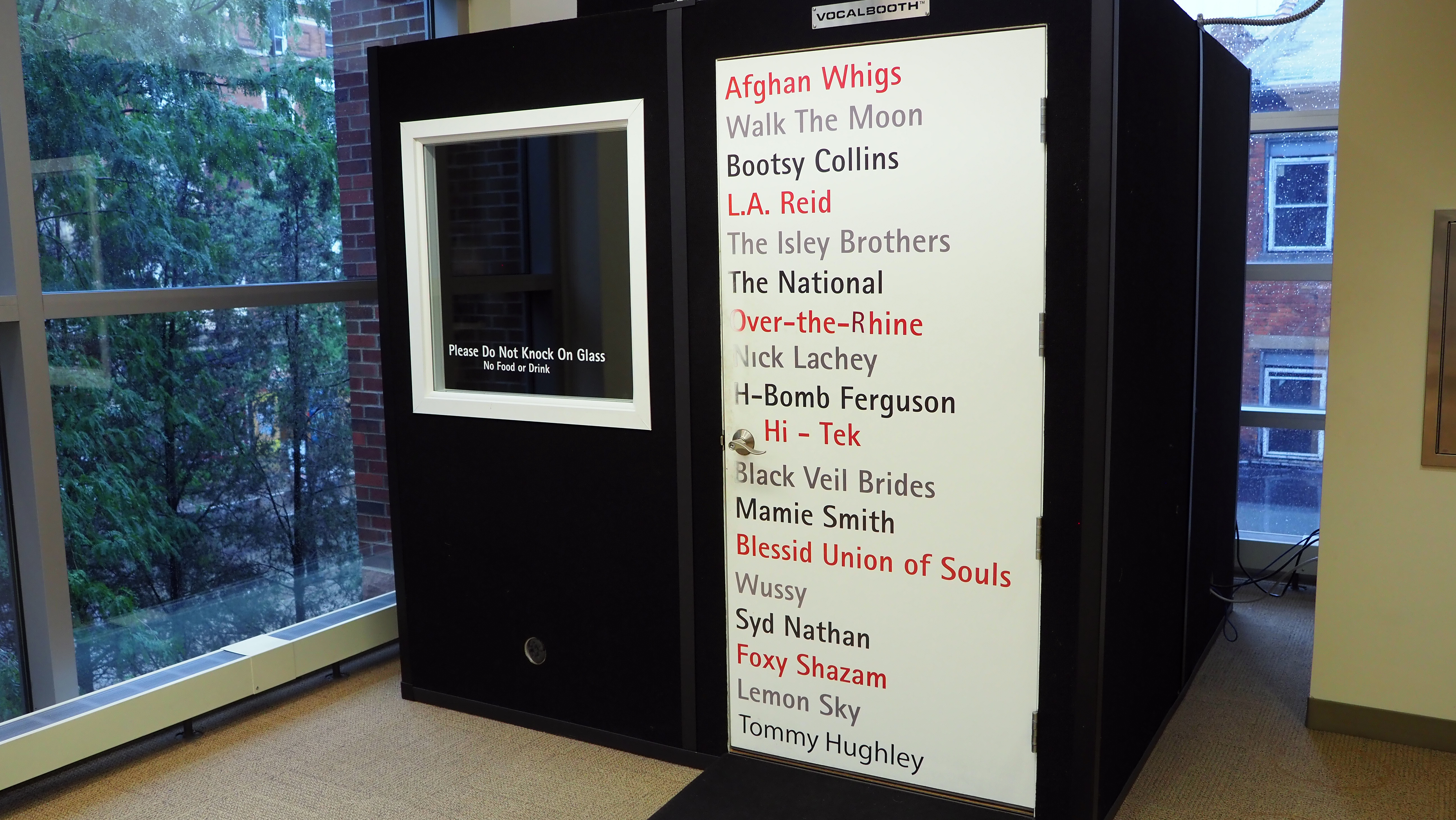 Photo of the outside of the audio recording booth featuring names of popular Cincinnati bands.