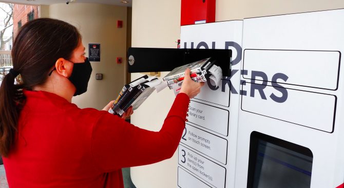 Woman using Hold lockers at the Oakley Branch Library