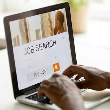 Person job searching on a laptop, Ebsco Job Career Accelerator