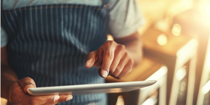 Man tapping screen of tablet, OverDrive Business